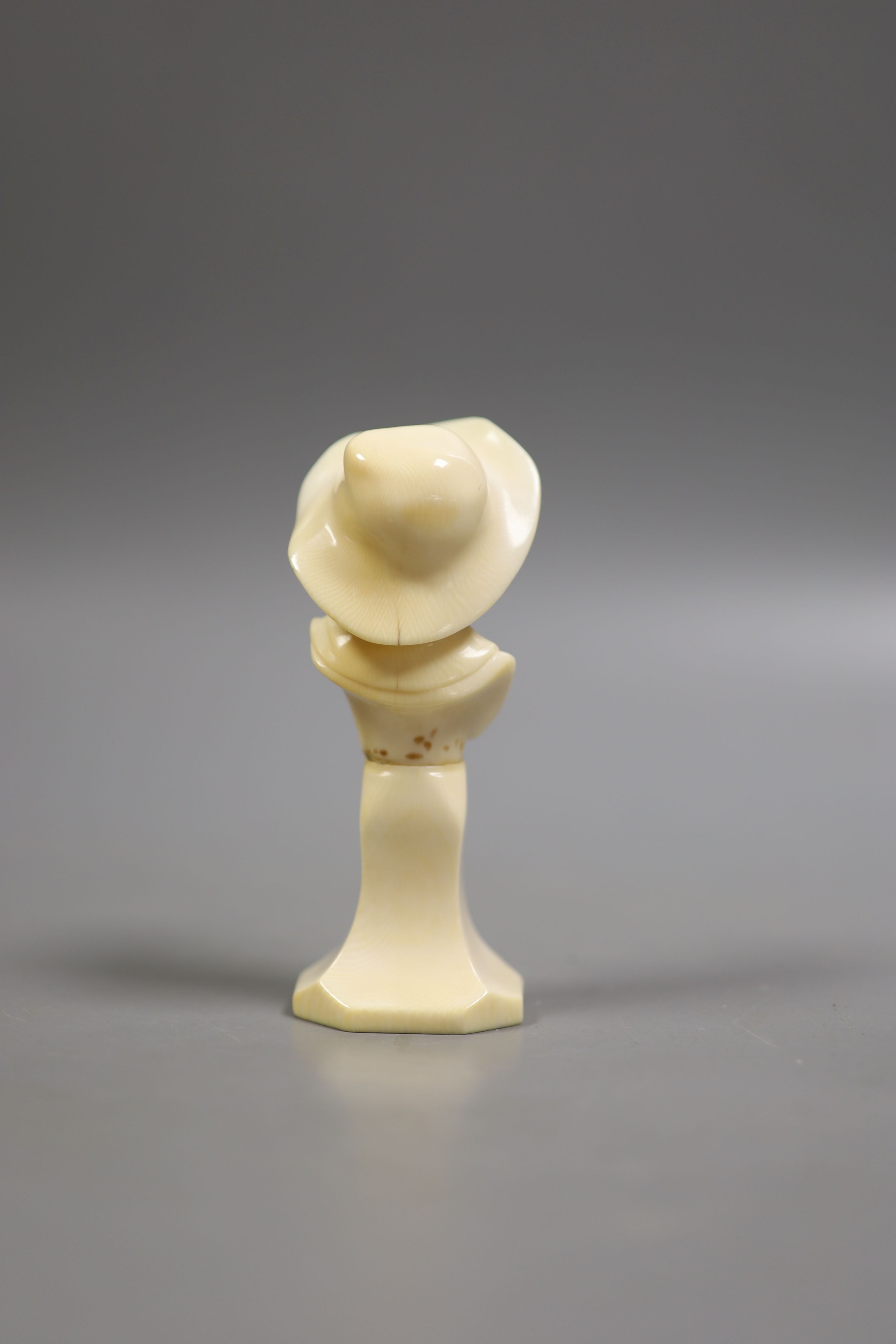 A carved ivory bust of a boy wearing a hat, early 20th century, 11.5 cm high